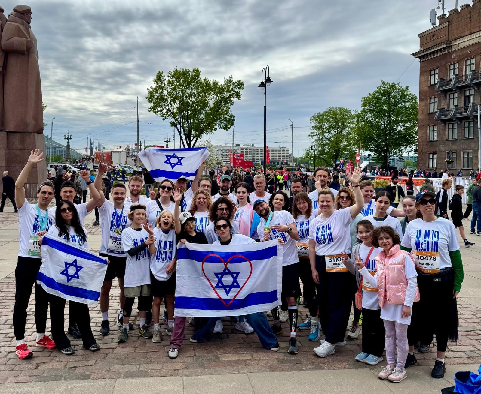 Run For Them solidarity marathon group in Riga with Israeli flags